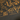 Black shirt with gold illustrations and text on a dark background