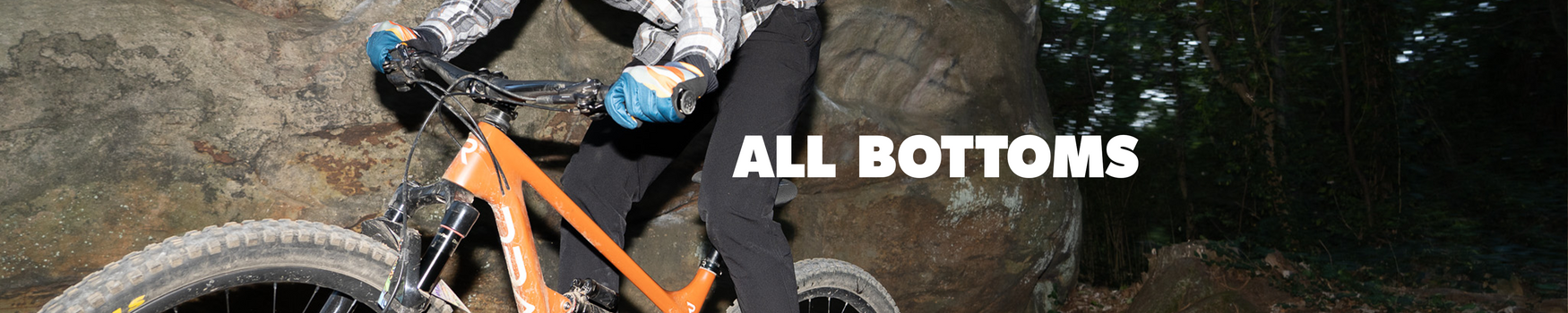 Person riding a mountain bike on rocky terrain with 'All Bottoms' text overlay.