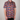 Person wearing a colorful mushroom pattern shirt against a plain background