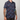 Person wearing a navy blue patterned shirt on a plain background