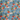 Tropical fabric pattern with palm trees, flowers, and sailboats on a blue background