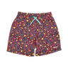 A pair of mens' swim trunks featuring a vibrant, multicolored retro pattern with pink, yellow, blue, and teal elements, complete with a light blue drawstring and a small white 'WILD' brand logo on the lower right leg.