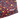 Close-up of a patterned fabric product corner with the visible brand name HINDUP. The material has a black base covered in a colorful retro 90s-style print with pink, yellow, and turquoise geometric shapes and abstract splatter details.