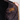 Close-up of a person opening a dark quilted jacket to show the interior lining and brown corduroy pocket flap.