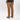 A person shown from the back wearing brown corduroy pants, a black t-shirt, and black Vans sneakers on a white studio background.