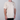 A man wearing a light beige crewneck t-shirt with a small black embroidered logo on the left chest, photographed against a neutral gray background.