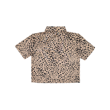 Beige shirt with black dot pattern on a white background