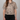 Person wearing a leopard print shirt against a gray background