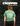 Person wearing a green t-shirt with text and graphics, standing against a dark forest background.