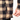 Close-up of a person wearing a plaid jacket with a hand adjusting the zipper.