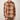 A man wearing a long-sleeve button-up flannel shirt with a brown, beige, and orange plaid pattern, paired with brown pants, photographed against a solid light gray background.