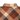 Close-up of a plaid flannel shirt collar and upper chest area with a warm brown, orange, and beige tartan pattern. The brand name 'HANDUP' is printed in white text on the chest.