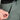 Person wearing green pants with a visible brand label, focusing on the waistband area.