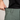 Person wearing green pants with a plain background