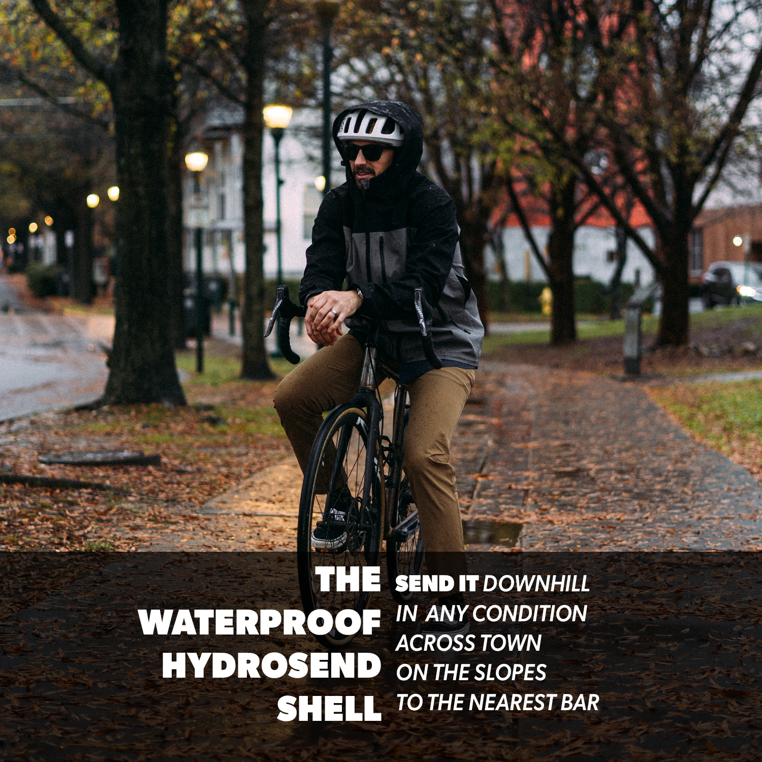 Person riding a bicycle on a path with autumn leaves and trees in the background.
