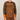 A man wearing a brown long-sleeve athletic shirt with an orange and yellow topographic contour pattern, featuring the IMBA logo on the chest and solid orange ribbed cuffs.