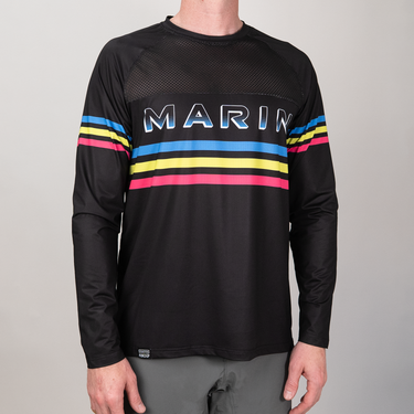 Black long-sleeve shirt with colorful stripes and 'MARIN' branding on a gray background