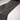 Close-up of a black athletic outfit with mesh design on a neutral background