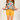 Person wearing a colorful floral shirt and yellow shorts pullng out leopard print pockets.