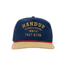 Navy blue cap with beige brim and gold text 