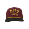 Maroon and black cap with yellow text on a white background