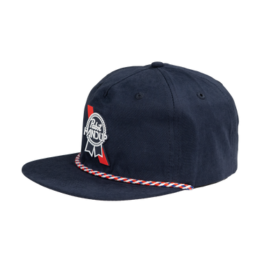 A navy blue flat-brim cap featuring a white and red 'Pilsner AND UP' ribbon patch on the front left and a red and white striped braided trim along the brim edge, shown against a plain white background.