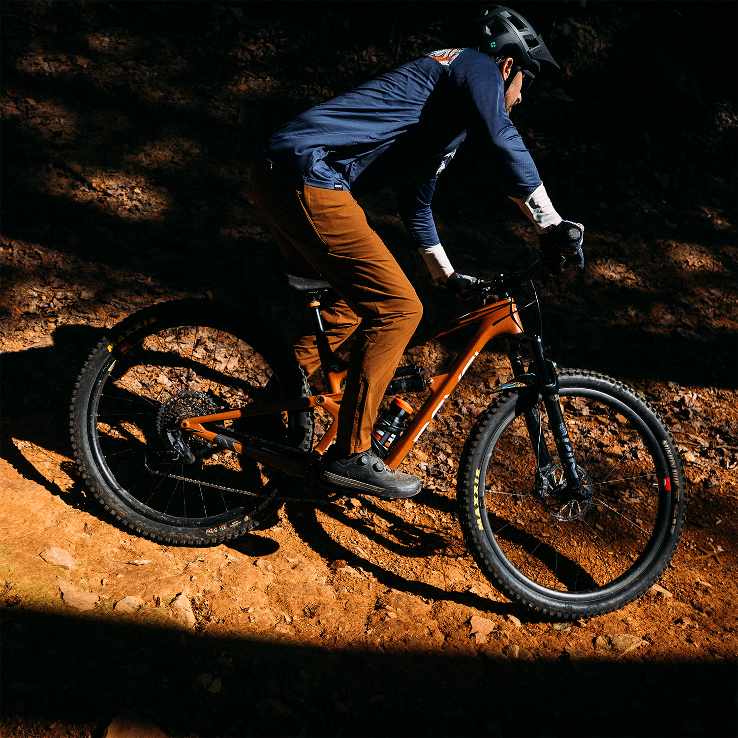 Person riding a mountain bike on a dirt trail at night