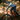 Man riding an orange mountain bike on a forest trail