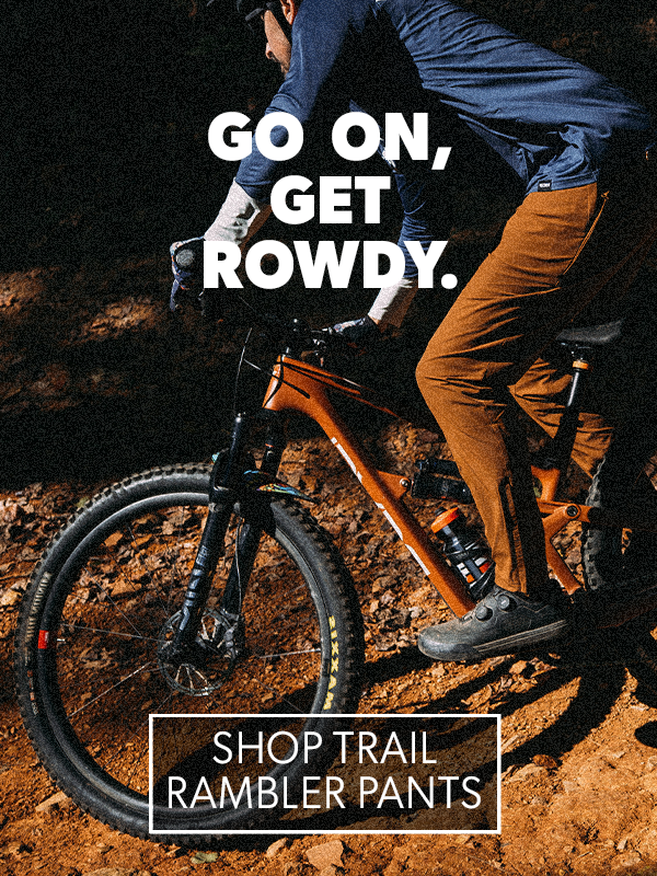 Person on a bike with text 'Go on, get rowdy' and promotional text for Trail Rambler Pants.