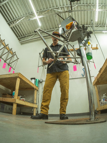 Person working on a metal structure in a workshop