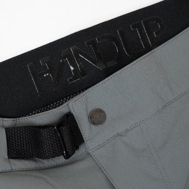 close up of the inseam of grey trail shorts featuring the HANDUP logo