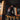 Person standing on a wooden deck with a dark background