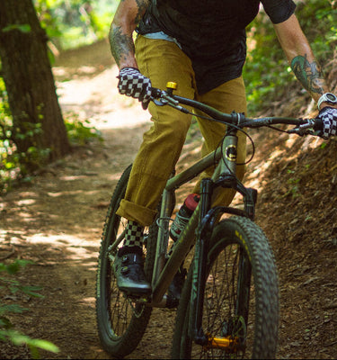 Man riding a mountain bike on a trail in a forest