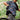 Person wearing a patterned shirt and helmet with a bike in a forest setting