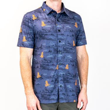 Person wearing a blue patterned shirt with orange and white designs on a white background