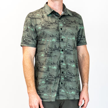 Person wearing a gray patterned shirt with a white background