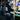Person interacting with a vending machine filled with various products at night.