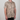 Person wearing a short-sleeve shirt with a cheetah print pattern on a plain background