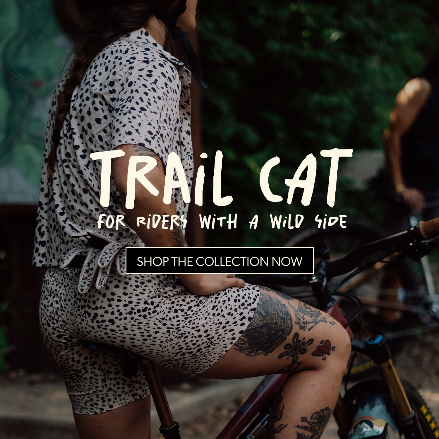 Mountain biker wearing matching spotted jersey and shorts with “Trail Cat” collection branding.
