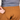 Brown pants with 'HANDUP' branding being zipped by a person wearing a gray shirt.
