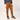 Person wearing brown pants and a blue jacket on a white background