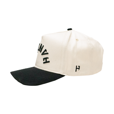 Two-tone cap with black and white design on a white background