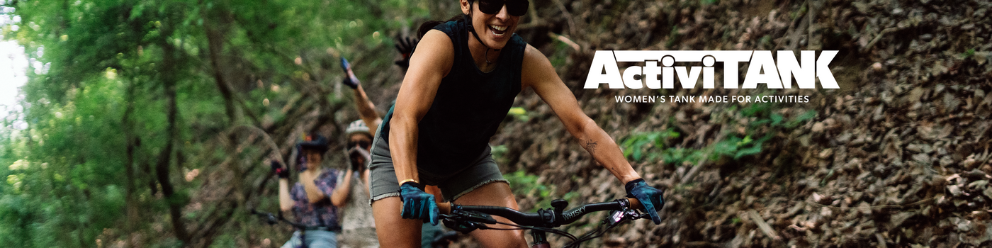 Woman mountain biking with 'ActivitANK' branding in the foreground