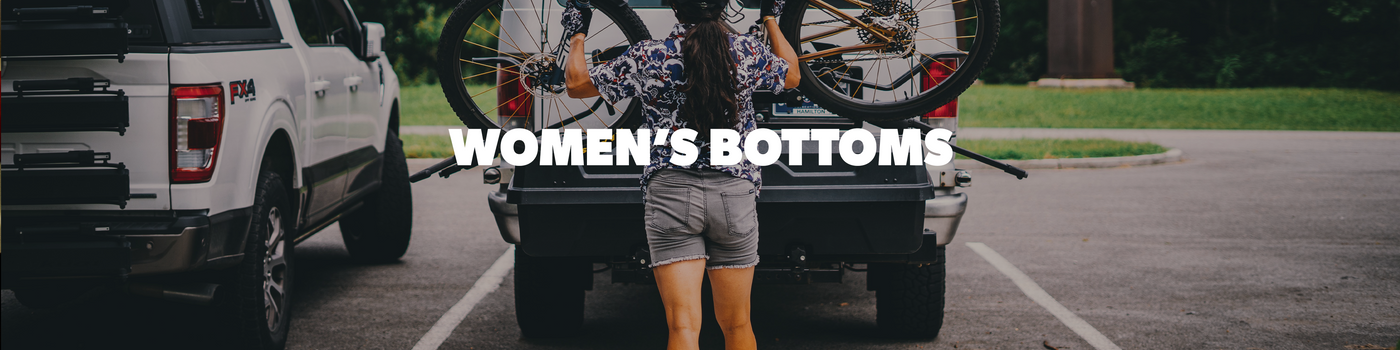 Person standing next to a truck with 'Women's Bottoms' text overlay.
