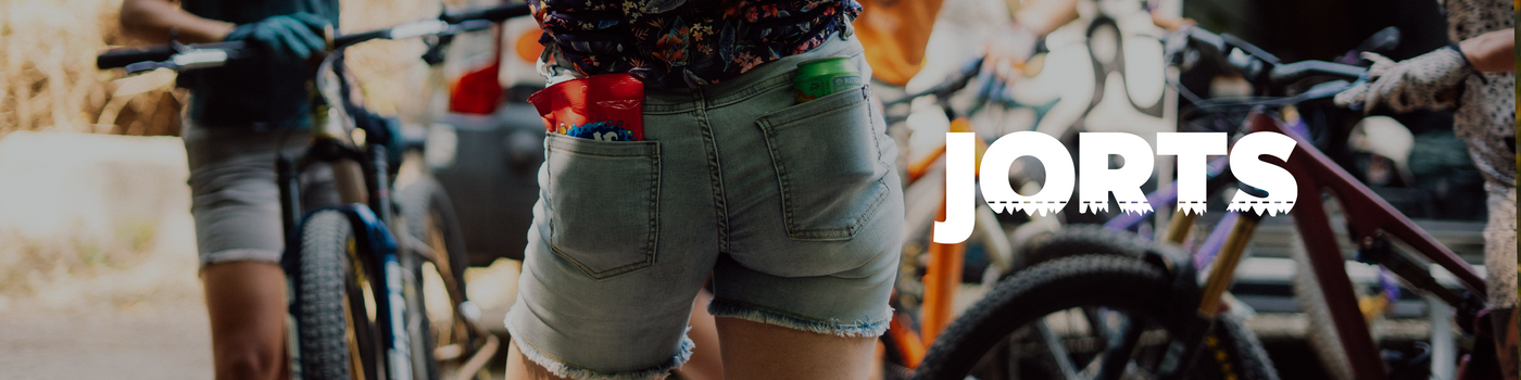 Person wearing Jorts shorts with bicycles in the background