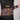 Person wearing a black cycling outfit with colorful patterned gloves and waistband, featuring the brand 'Handup'.