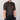 Person wearing a black and orange patterned cycling jersey on a gray background