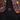 Black backpack with colorful abstract patterns on the backrest, featuring the brand 'Handup'.