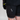 Close-up of black cycling shorts with brand logo on a neutral background