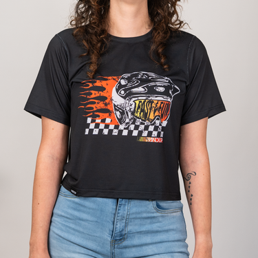Person wearing a black t-shirt with a graphic design on a plain background
